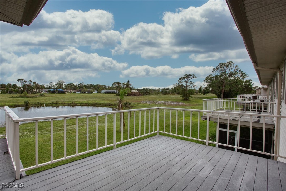 5917 Littlestone Court, Unit 118 North Fort Myers, FL 33903 - Photo 18 of 20 a view of balcony with wooden floor and fence