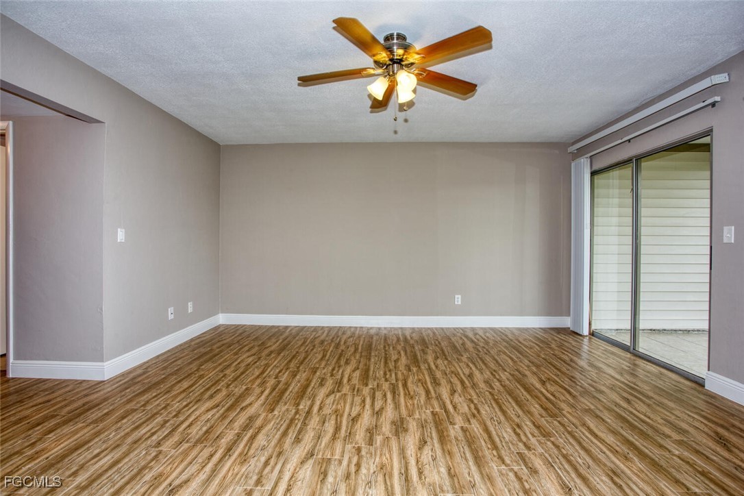 5917 Littlestone Court, Unit 118 North Fort Myers, FL 33903 - Photo 6 of 20 a view of an empty room with window and wooden floor
