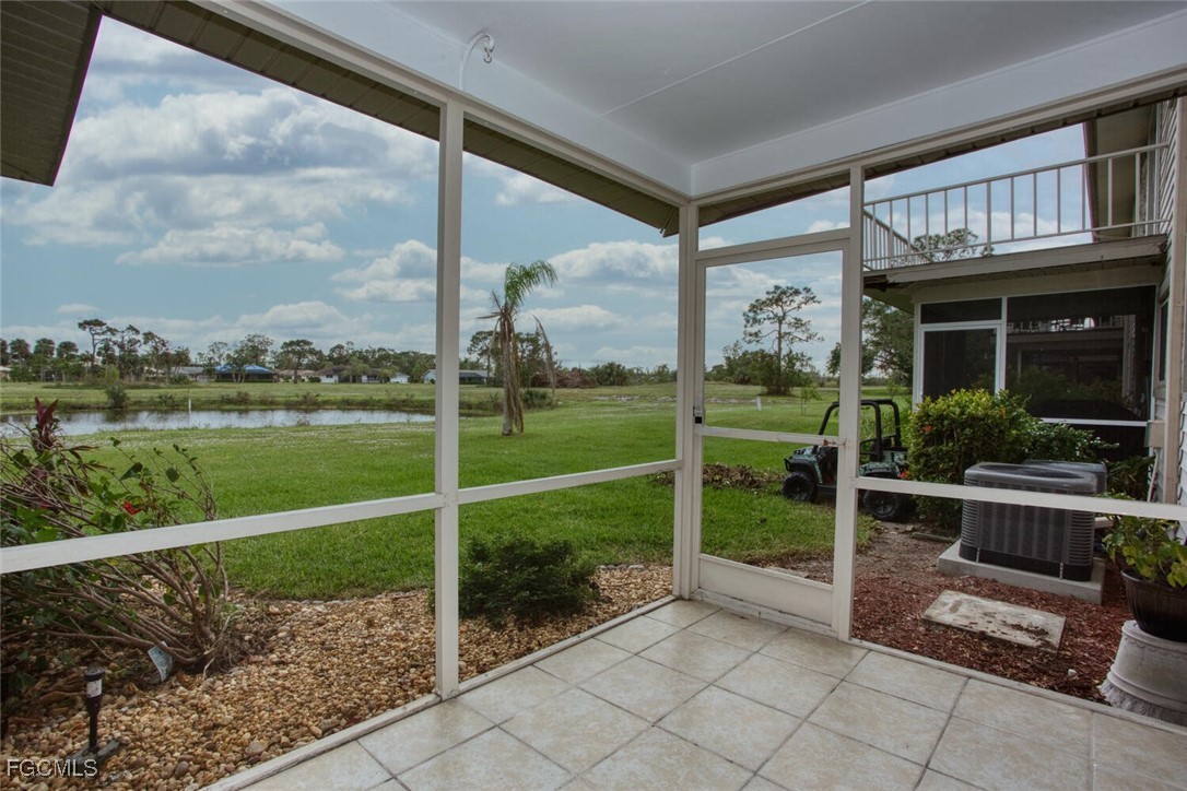 5917 Littlestone Court, Unit 118 North Fort Myers, FL 33903 - Photo 7 of 20 a view of a porch with a table chairs and a yard