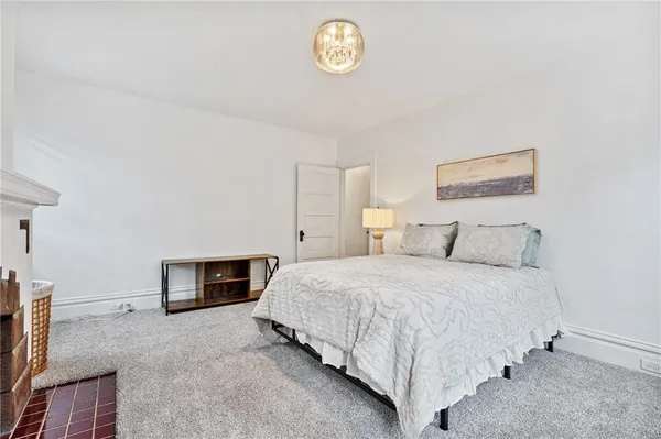 a spacious bedroom with a bed and a window