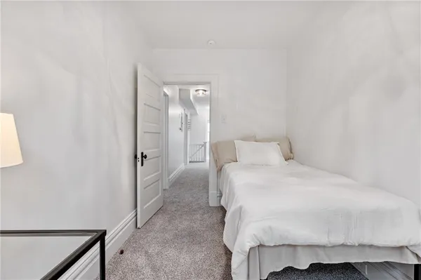 a large bed sitting in a bedroom next to a bathroom