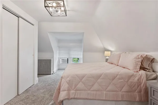 a large white bed in a white room