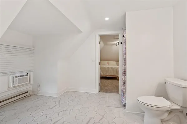 a bathroom with a toilet and a shower