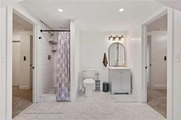 a bathroom with a toilet a sink and shower