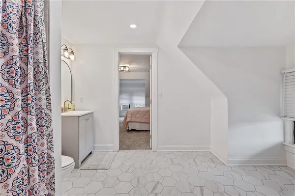 a view of a hallway with closet and bathroom
