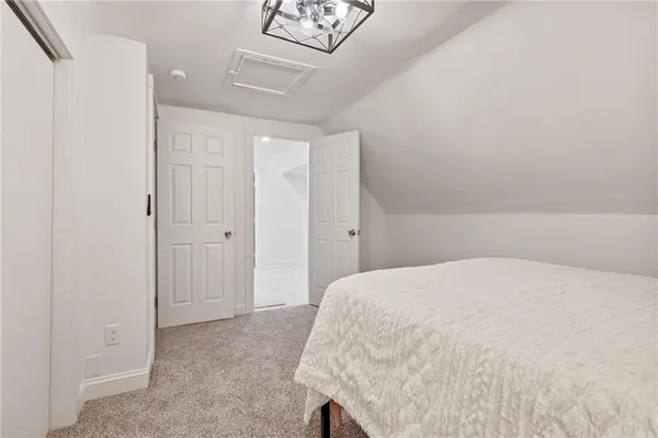 a large white bed in a white room