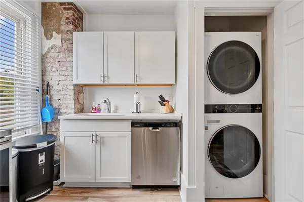 a utility room with sink dryer and washer
