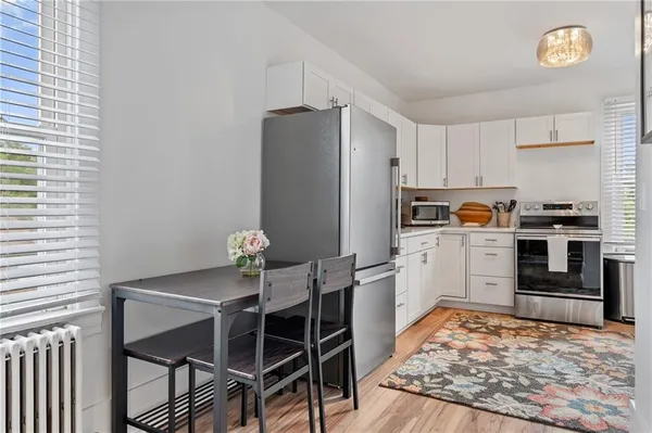 a kitchen with stainless steel appliances granite countertop a stove refrigerator sink and cabinets