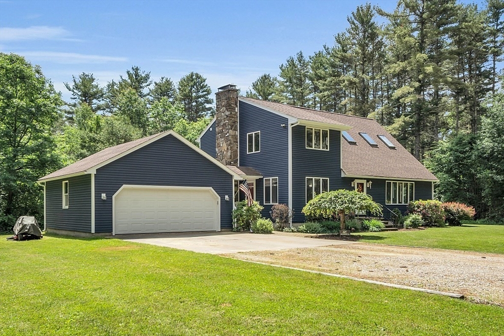 73 Off Ruggles Street Gilbertville, MA 01031 - Photo 1 of 38 a front view of house with yard and trees around