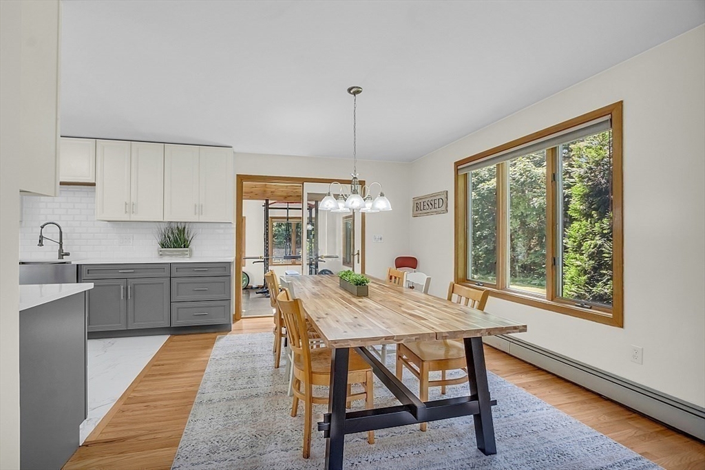 73 Off Ruggles Street Gilbertville, MA 01031 - Photo 11 of 38 a kitchen with a table chairs sink and cabinets