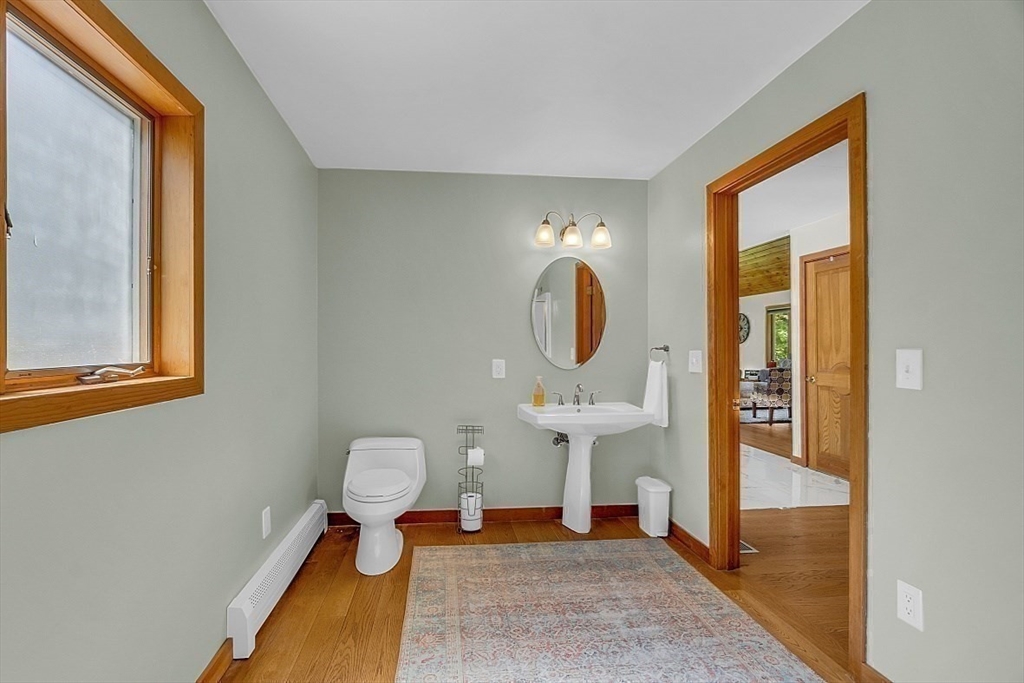 73 Off Ruggles Street Gilbertville, MA 01031 - Photo 13 of 38 a bedroom with a bed and wooden floor