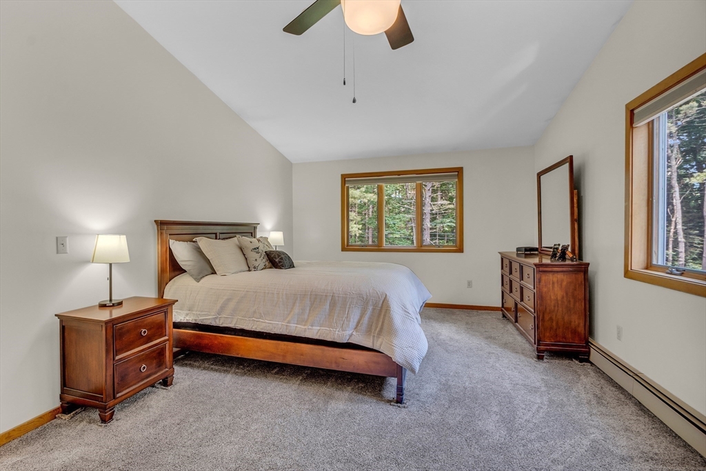 73 Off Ruggles Street Gilbertville, MA 01031 - Photo 24 of 38 a bedroom with a bed and a chandelier