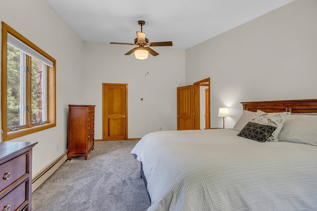 73 Off Ruggles Street Gilbertville, MA 01031 - Photo 25 of 38 a bedroom with a bed and a chandelier