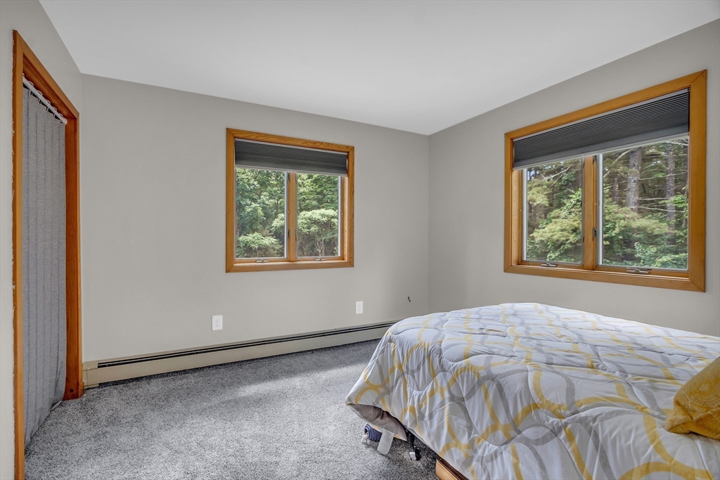 73 Off Ruggles Street Gilbertville, MA 01031 - Photo 27 of 38 a bed sitting in a bedroom next to a window