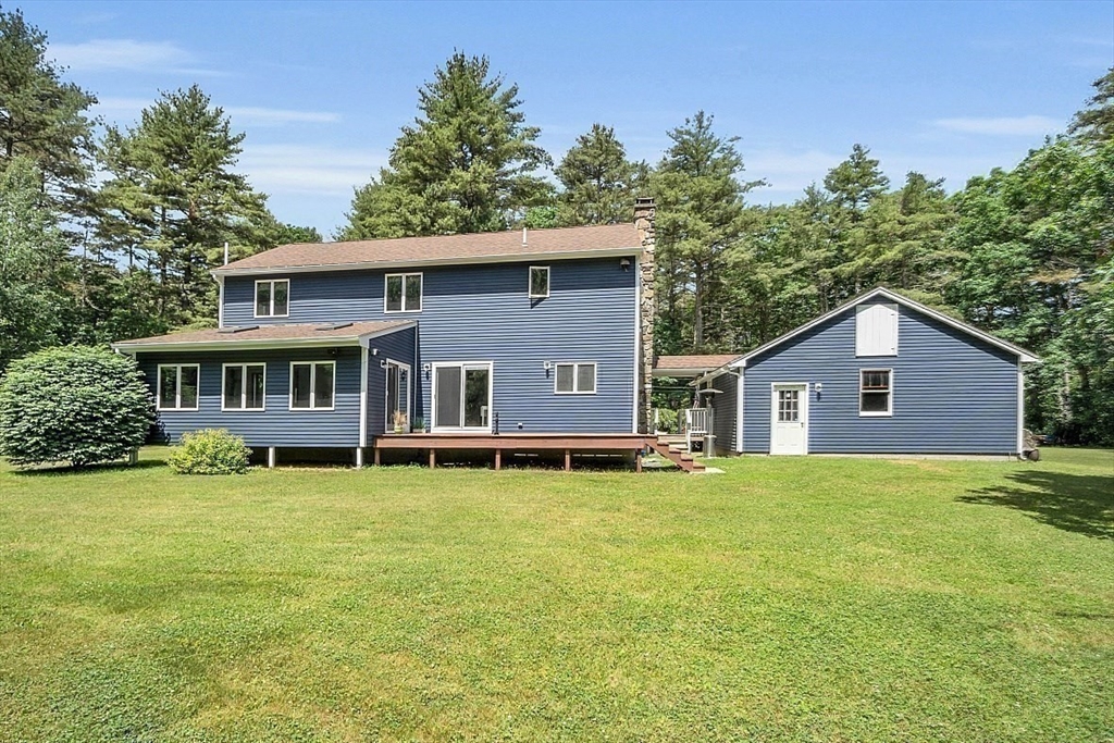 73 Off Ruggles Street Gilbertville, MA 01031 - Photo 31 of 38 a house that is sitting in the grass with large trees