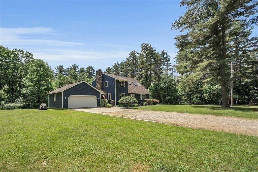 73 Off Ruggles Street Gilbertville, MA 01031 - Photo 36 of 38 a front view of a house with a yard and trees