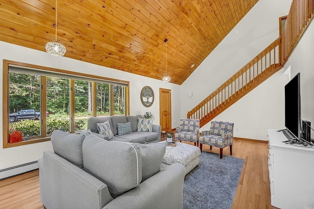 73 Off Ruggles Street Gilbertville, MA 01031 - Photo 4 of 38 a living room with furniture a flat screen tv and a floor to ceiling window