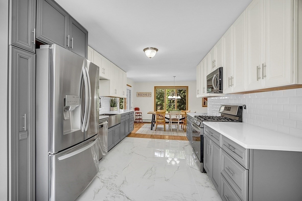 73 Off Ruggles Street Gilbertville, MA 01031 - Photo 8 of 38 a kitchen with stainless steel appliances granite countertop a refrigerator and a stove top oven