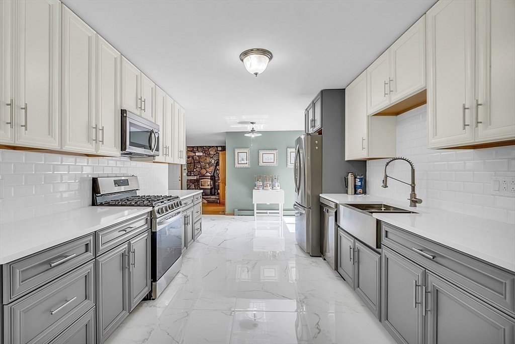 73 Off Ruggles Street Gilbertville, MA 01031 - Photo 9 of 38 a large kitchen with stainless steel appliances granite countertop a stove and a sink