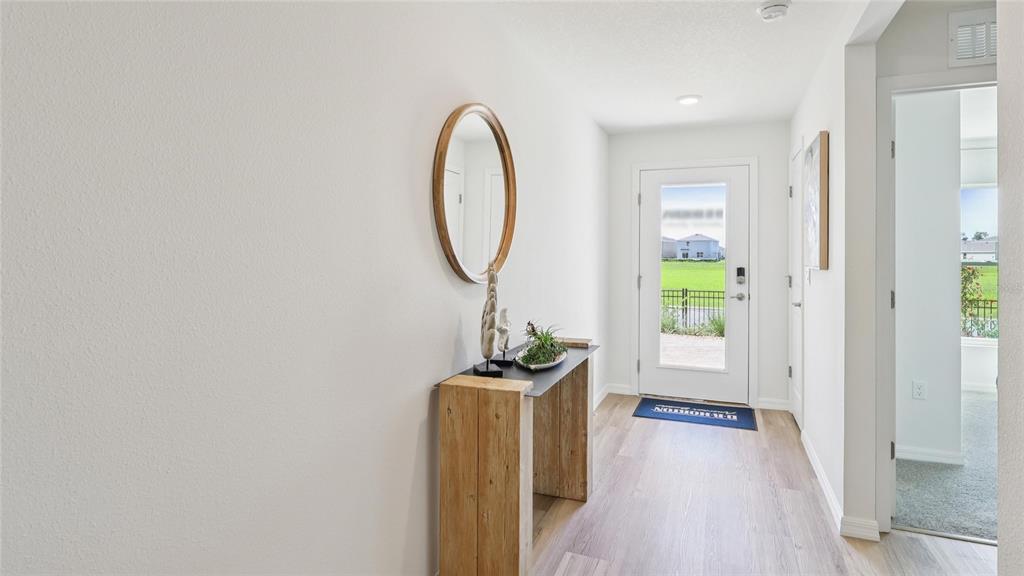 24229 Northwest 10th Road Newberry, FL 32669 - Photo 2 of 21 a view of a room with wooden floor mirror and windows