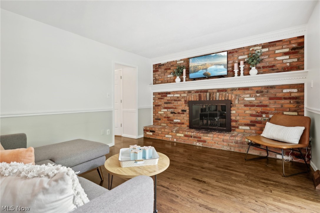 139 Solon Road Chagrin Falls, OH 44022 - Photo 16 of 41 Family room featuring brick wall, a brick fireplace and hardwood floors