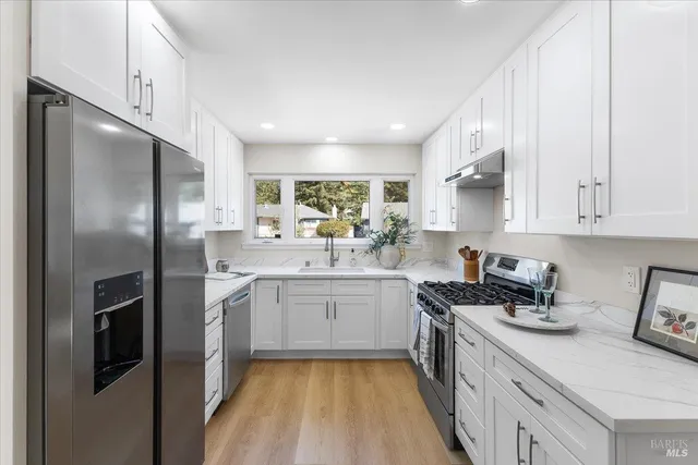 a kitchen with a sink stove and refrigerator