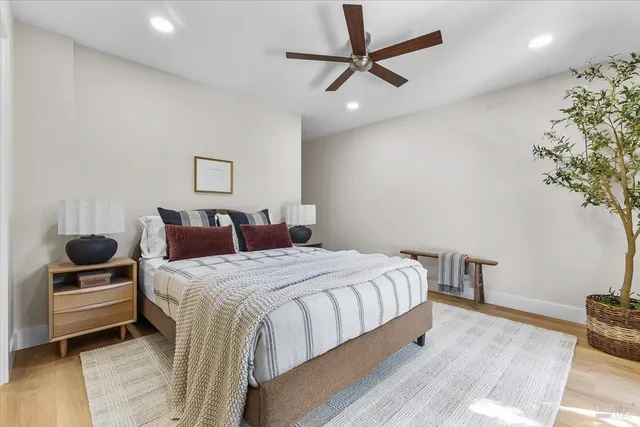 a bathroom with a toilet a sink a vanity and mirror