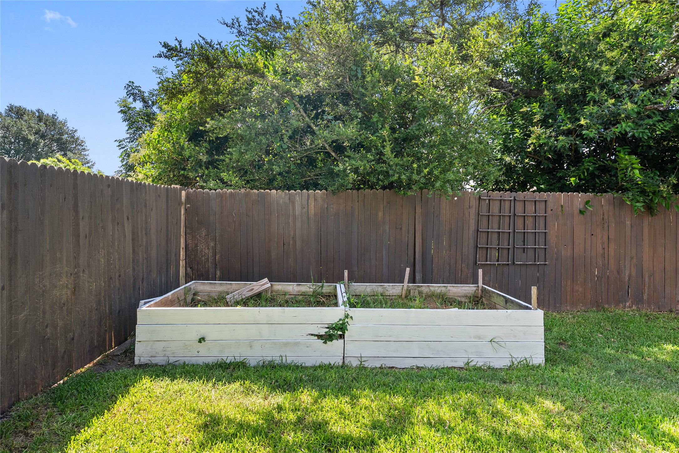 9024 Heiden Lane Austin, TX 78749 - Photo 32 of 33 The garden planters add structure and pops of green along the backyard perimeter, completing this thoughtful outdoor landscape
