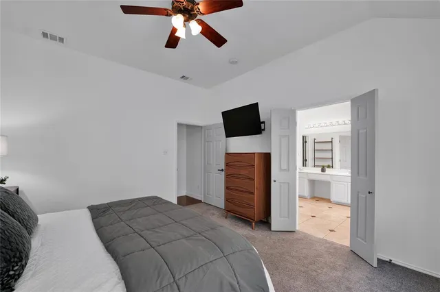 a bedroom with a bed and a television