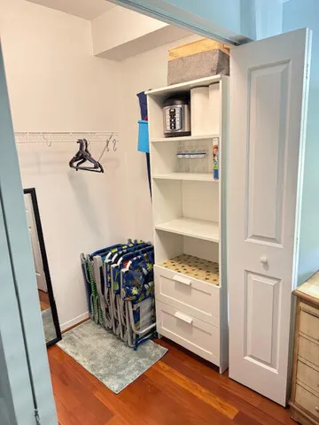 a view of walk in closet with clothes and shoes