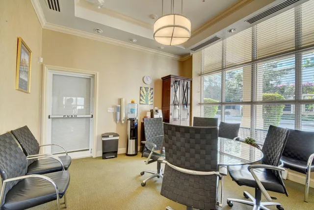 a view of a livingroom with workspace and a window