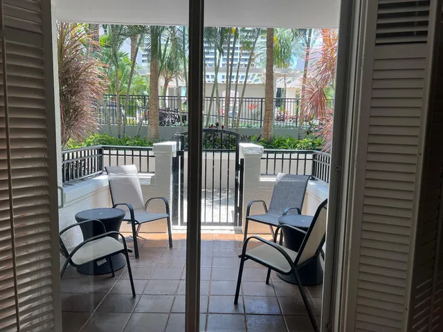 a bedroom with a bed and a potted plant on the dresser