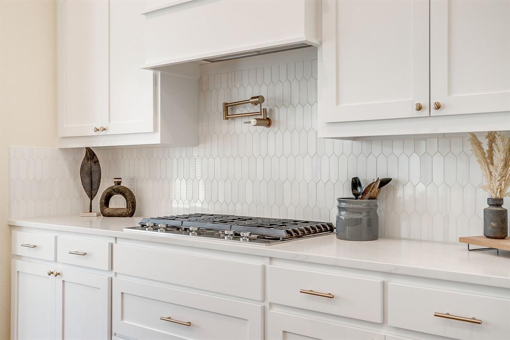 13921 Riviera East Fort Worth, TX 76028 - Photo 16 of 40 a kitchen with a stove and cabinets