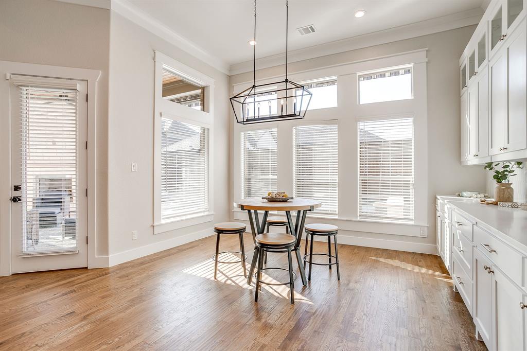 13921 Riviera East Fort Worth, TX 76028 - Photo 18 of 40 a view of a dining room with furniture windows and wooden floor