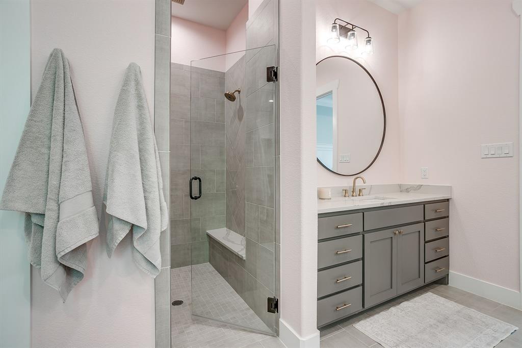 13921 Riviera East Fort Worth, TX 76028 - Photo 27 of 40 a bathroom with a double vanity sink and mirror with shower