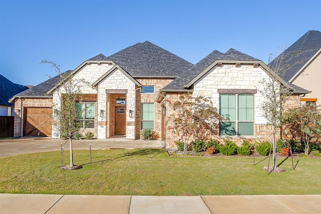 13921 Riviera East Fort Worth, TX 76028 - Photo 3 of 40 front view of a house with a yard