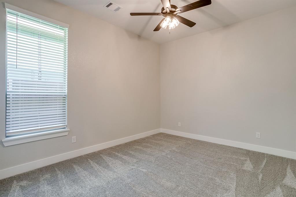 13921 Riviera East Fort Worth, TX 76028 - Photo 31 of 40 an empty room with a window and a fan