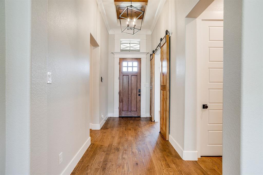 13921 Riviera East Fort Worth, TX 76028 - Photo 5 of 40 a view of a hallway with wooden floor