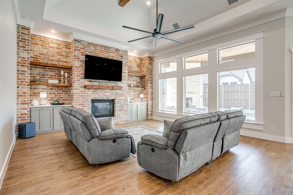 13921 Riviera East Fort Worth, TX 76028 - Photo 7 of 40 a living room with fireplace furniture and a flat screen tv