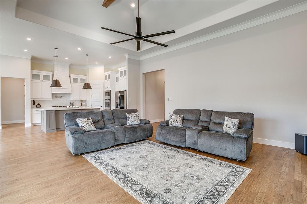 13921 Riviera East Fort Worth, TX 76028 - Photo 9 of 40 a living room with furniture and a wooden floor