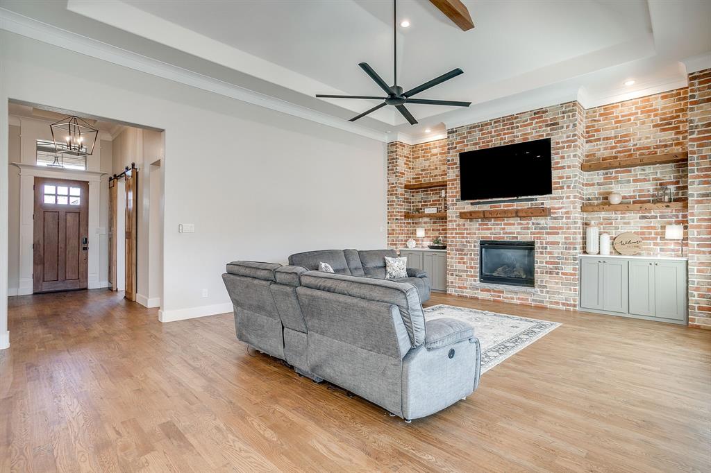 13921 Riviera East Fort Worth, TX 76028 - Photo 10 of 40 a living room with furniture fireplace and flat screen tv