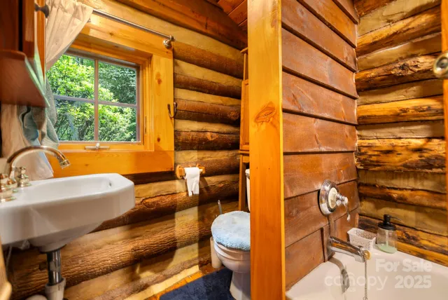 a view of a bathroom with shower and mirror