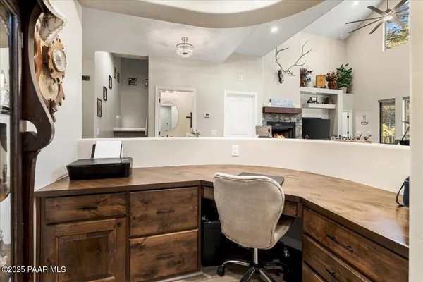 a dining room with wooden floor a chandelier a wooden table and chairs