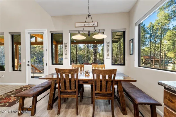 a large kitchen with a table and chairs