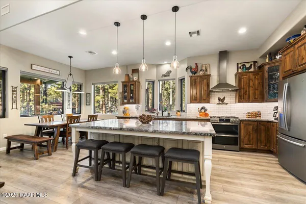 a kitchen with stainless steel appliances granite countertop a stove and cabinets