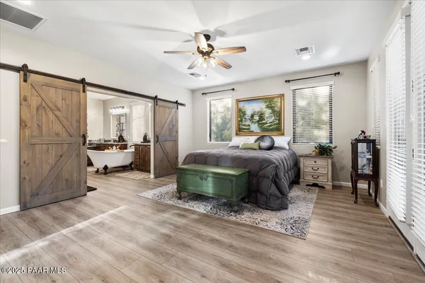 a bedroom with a large bed and a window