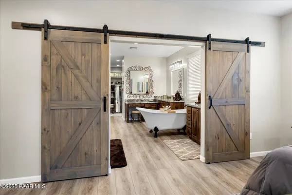 a large white kitchen with a large window and stainless steel appliances