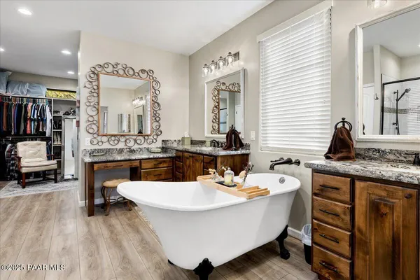 a view of walk in closet with clothes and shoes