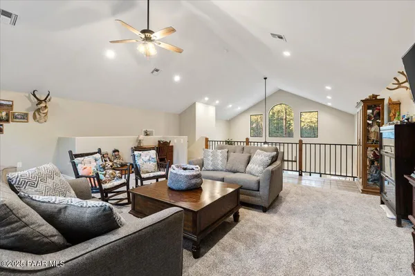 a living room with fireplace furniture and a flat screen tv