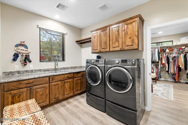 a view of a hallway with wooden floor and a bathroom